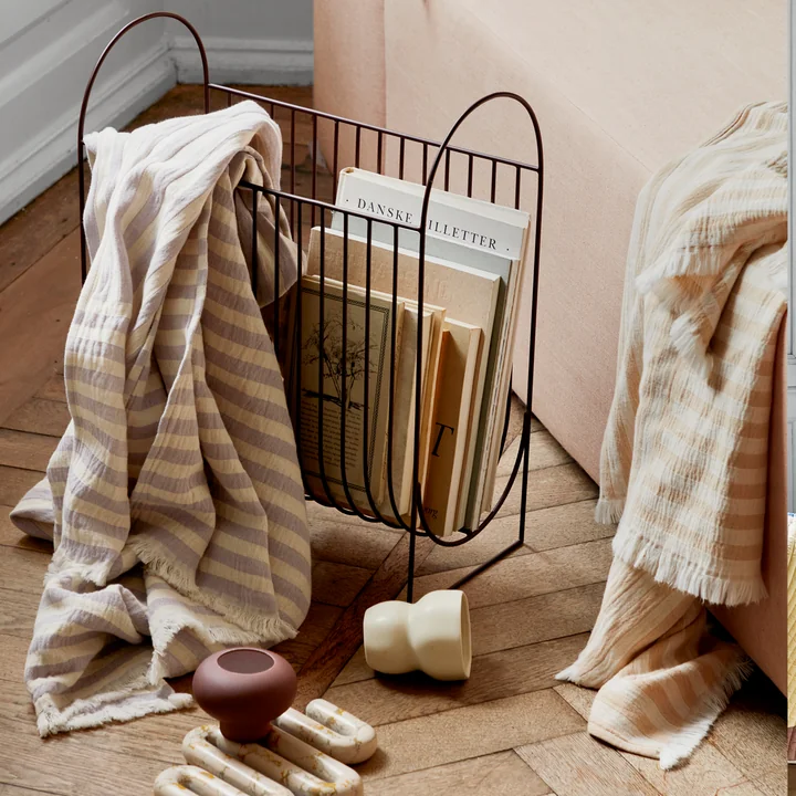 The Maggie magazine holder from Broste Copenhagen with books and a throw over