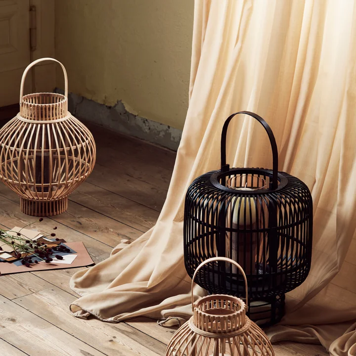 The delicate Globus lanterns from Broste Copenhagen on the wooden floor