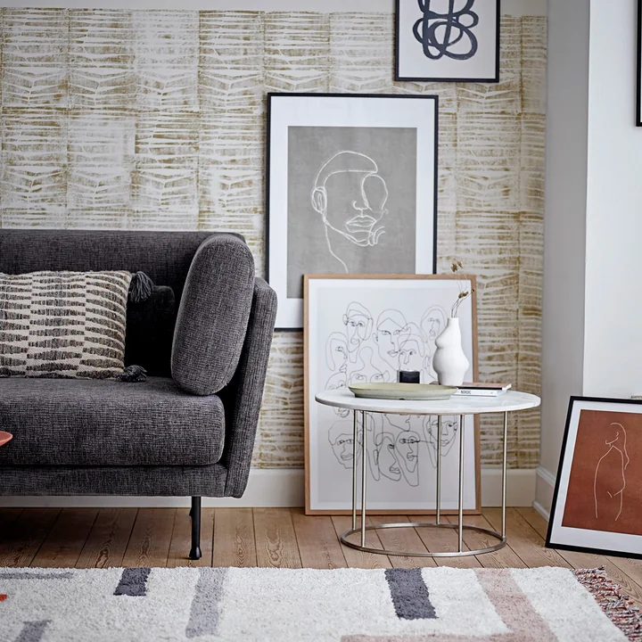 The Elora vase from Bloomingville on a table next to the couch