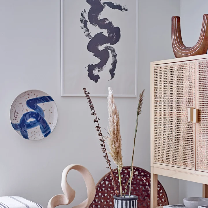 The Oscar wall plate from Bloomingville on the wall next to other decorative objects