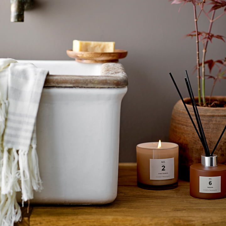 The ILLUME diffuser from Bloomingville next to the scented candle in the bathroom