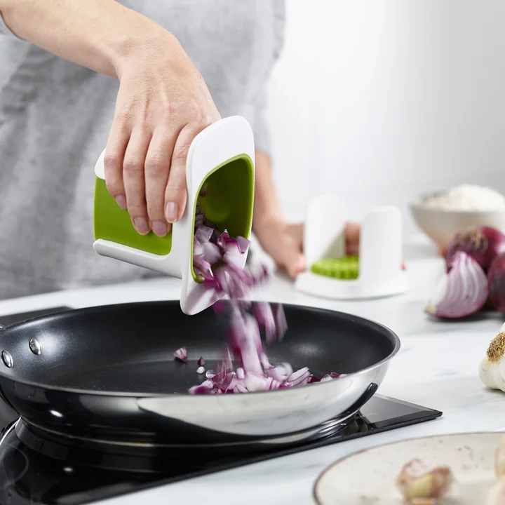 The ChopCup vegetable chopper with container from Joseph Joseph frying onions
