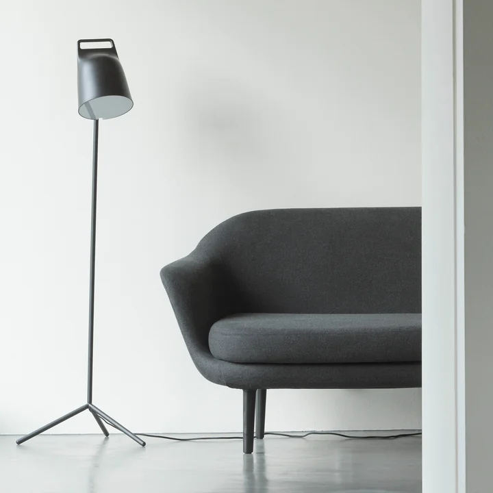 The Stage LED floor lamp from Normann Copenhagen next to a grey couch