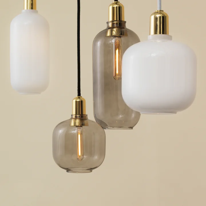The Amp Pendant lamps from Normann Copenhagen with shiny brass