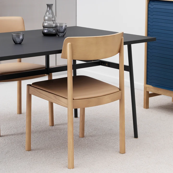 The upholstered Timb chair from Normann Copenhagen at the black dining table