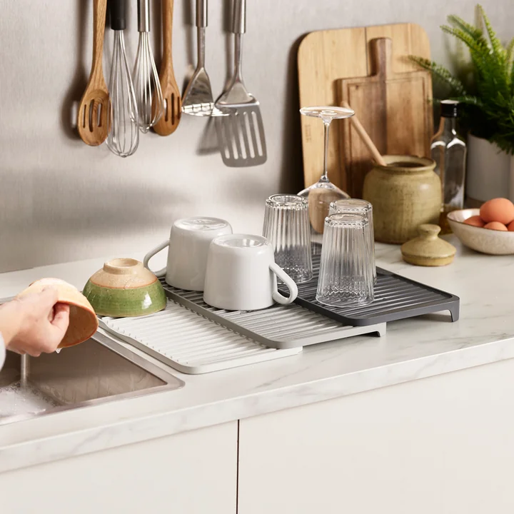 The extended Tier Extendable draining mat from Joseph Joseph next to the sink
