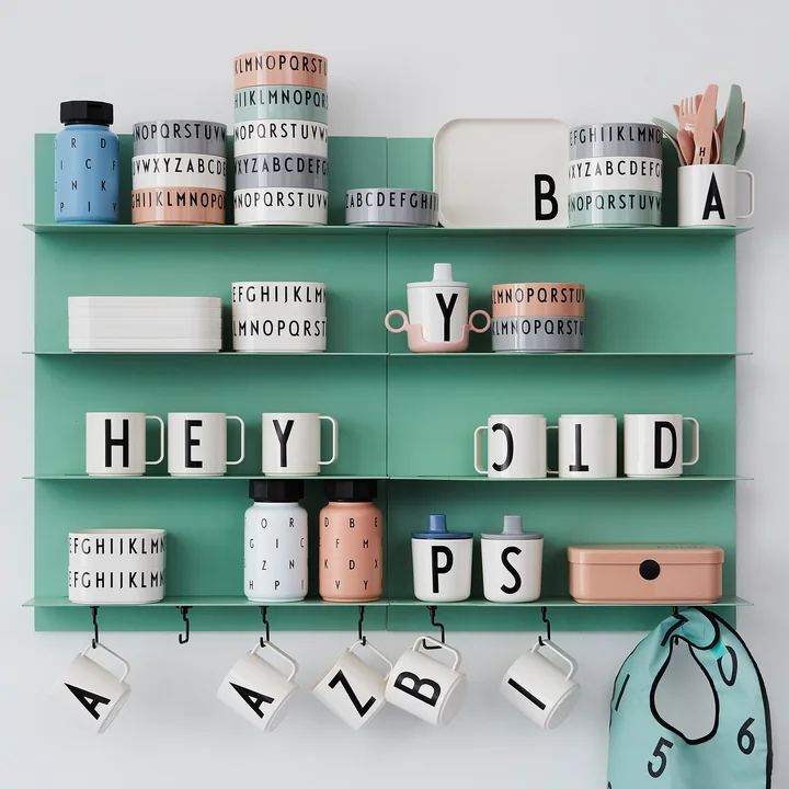 Bowls, cups, cans and bottles from Design Letters on a wall shelf
