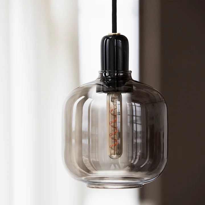 The Amp Pendant lamp from Normann Copenhagen with smoky glass