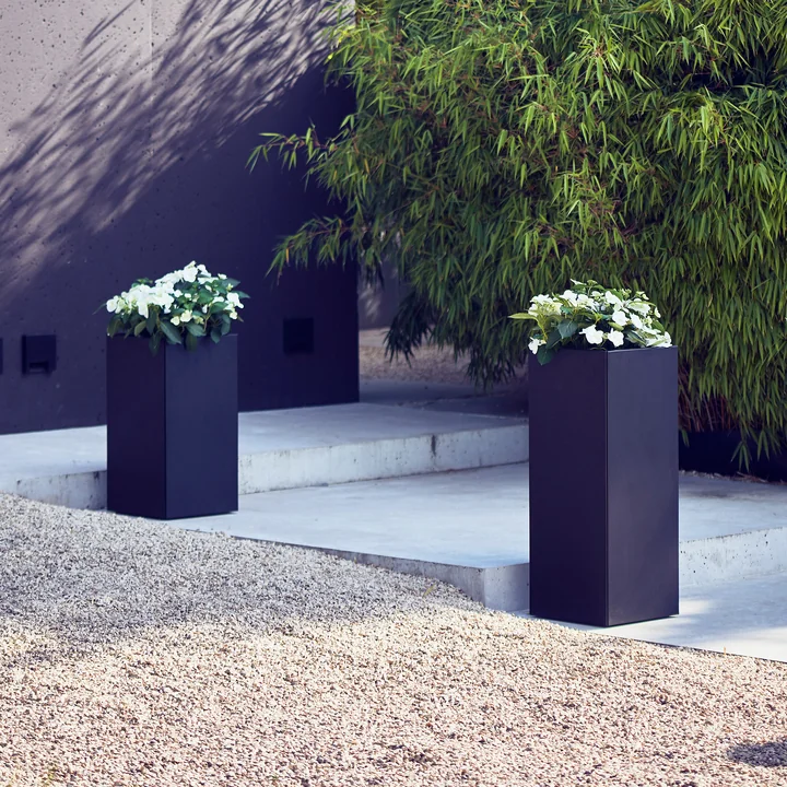 The Planter planters from Jan Kurtz on a stone pathway.