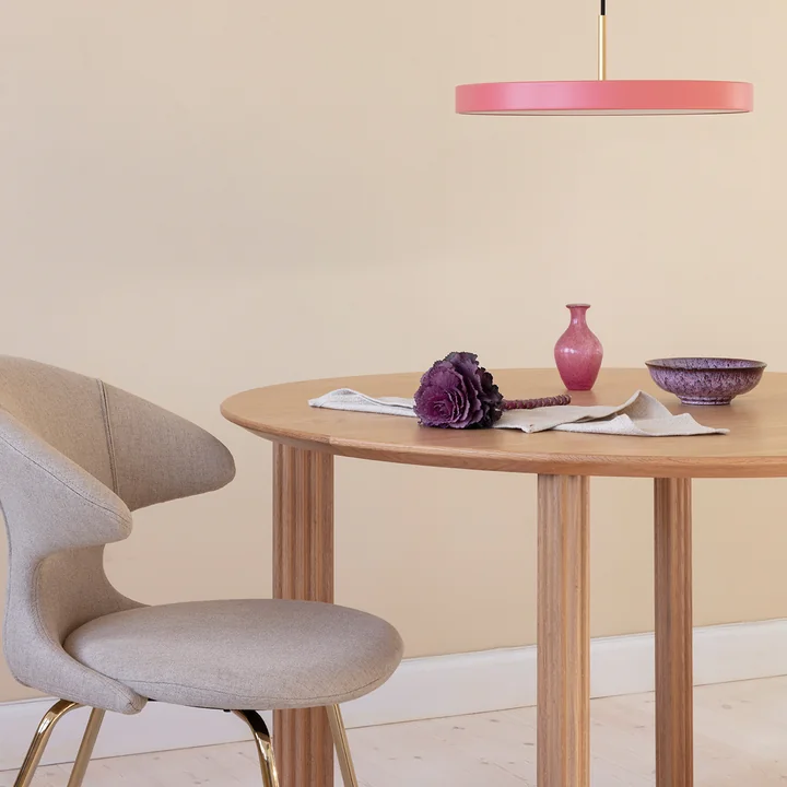 The carved legs of the Comfort Circle dining table from Umage