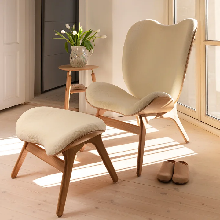 The A Conversation Piece Tall armchair and ottoman from Umage invite you to relax