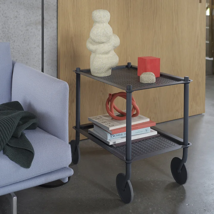 The Flow side trolley from Muuto as a side table next to the couch