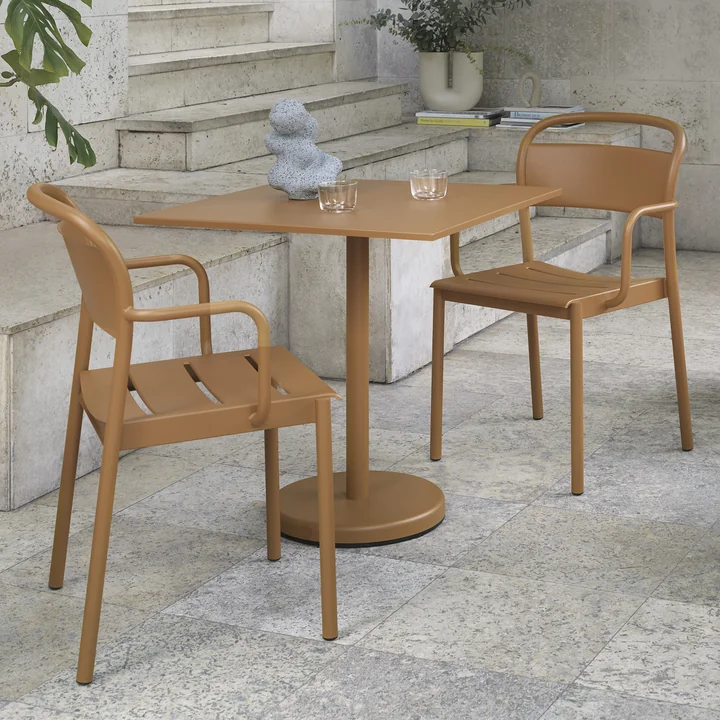 The Linear Steel table from Muuto with the Linear Steel Armchairs on a stone terrace