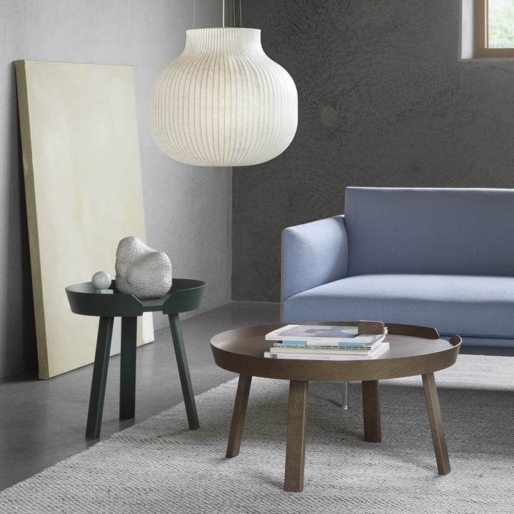 The Around tables from Muuto next to a light blue sofa in the living room