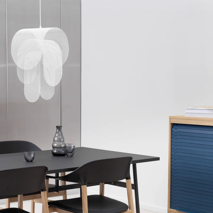 The Superpose pendant lamp from Normann Copenhagen over a black table