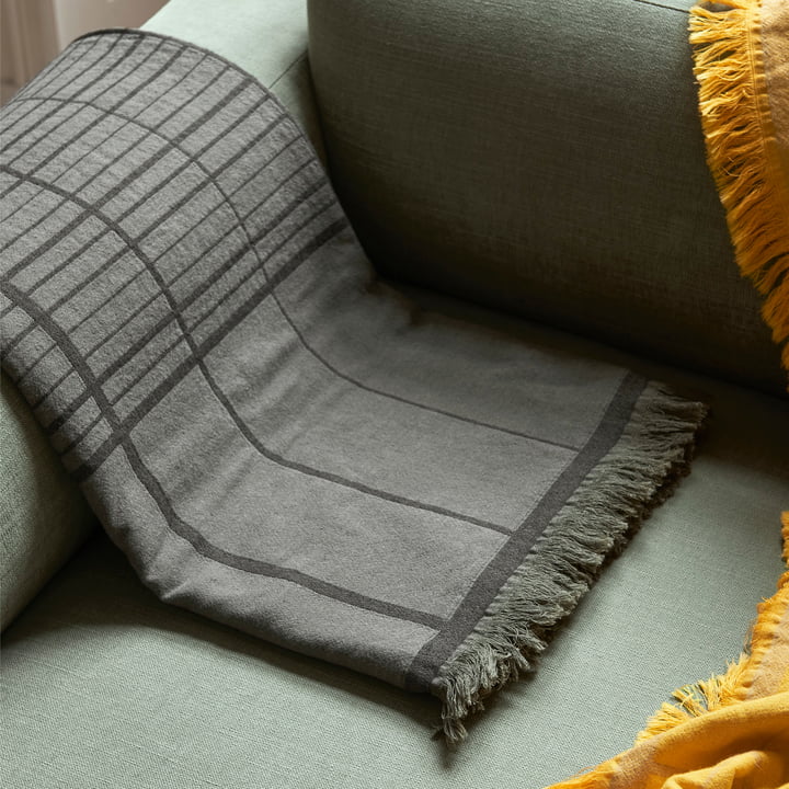 The Untitled AP10 bedspread from & Tradition contrasts with the sofa