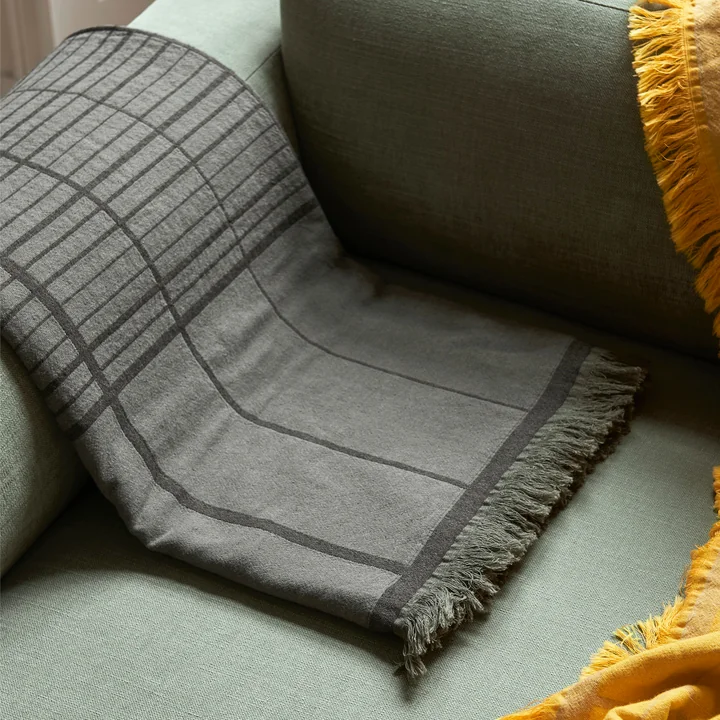 The Untitled AP10 bedspread from & Tradition contrasts with the sofa