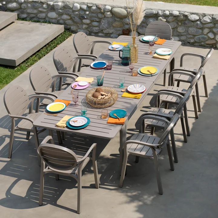 The Palma armchairs at the Alloro extending table from Nardi on the stone terrace