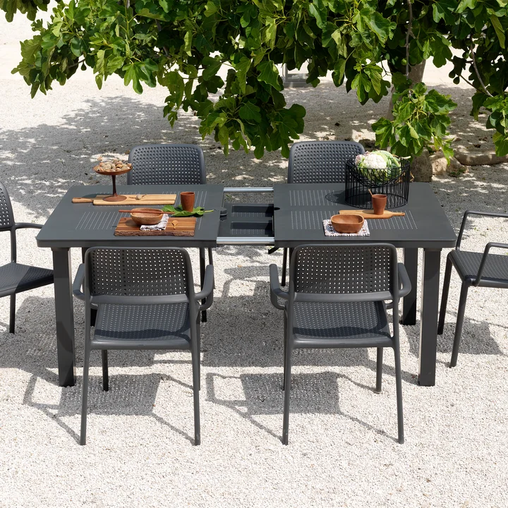The Levante extending table from Nardi with grey armchairs outside