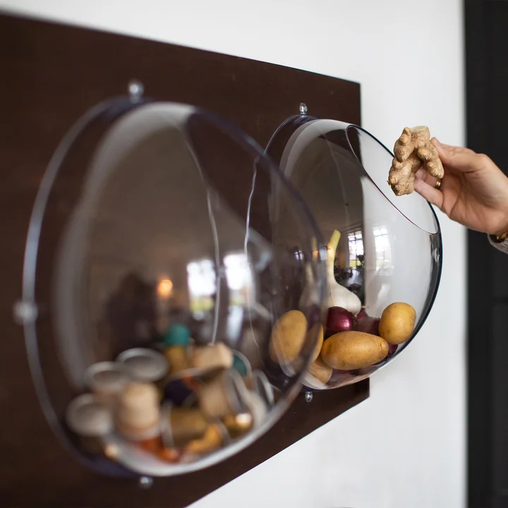 The Orion hanging displays from Koziol filled with vegetables and coffee capsules