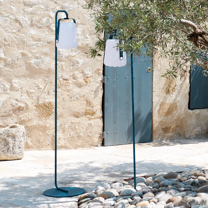 The Balad Battery LED lights from Fermob as floor lamps with frame and ground spike