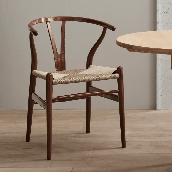 The CH24 Wishbone Chair in the Birthday Edition 2021 from Carl Hansen next to an oak table
