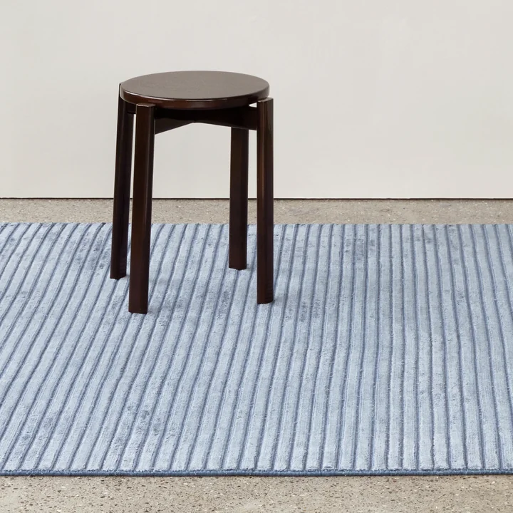 The Passage stool on the blue Houkime rug from Audo