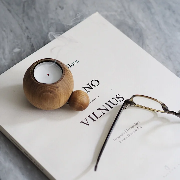 The RoundNRound candle and tea light holder by applicata on a book