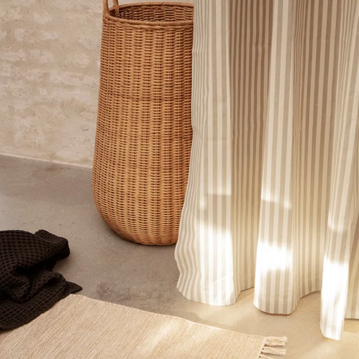 Chambray Shower curtain, melange bath mat and rattan laundry basket from Ferm Living