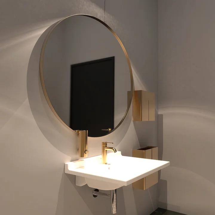 The round Unu wall mirror from Frost in the bathroom above the washbasin
