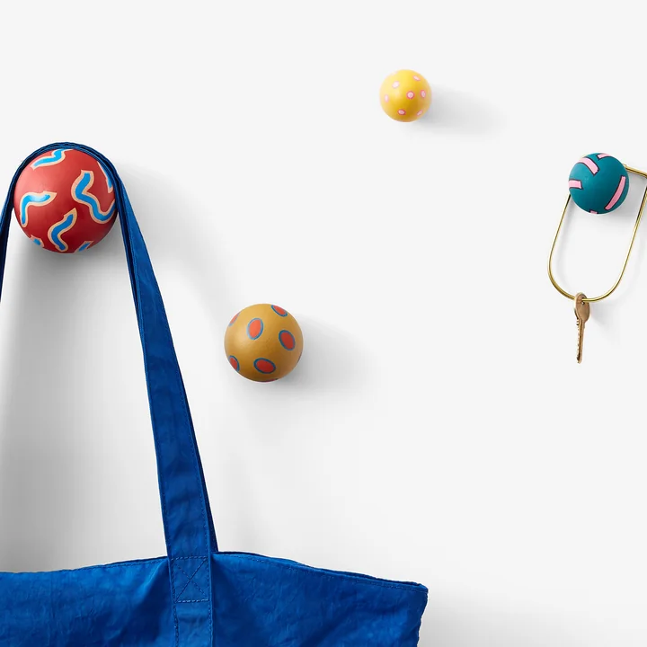 The Chiaozza wall hooks from Areaware on the wall with bag