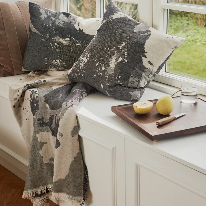 The Floreo cushion & Plaid from AYTM in a stylish lounge corner