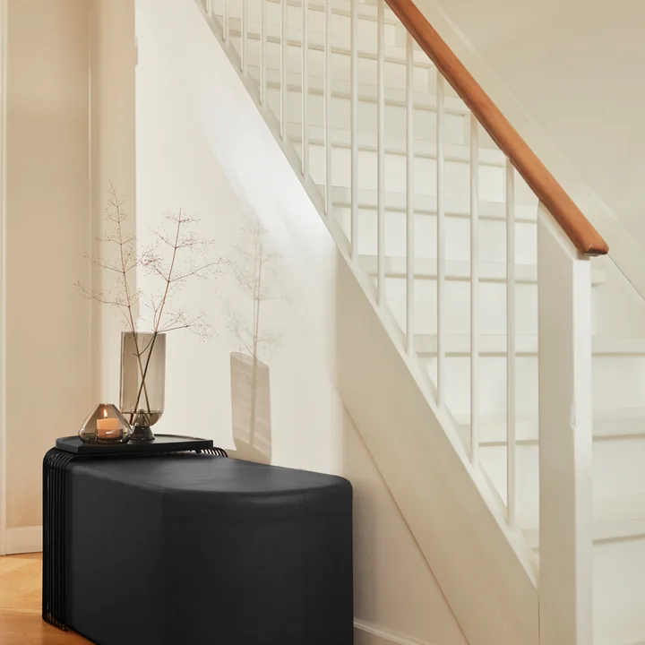 The Glacies vase on the Sessio pouf from AYTM in the hallway