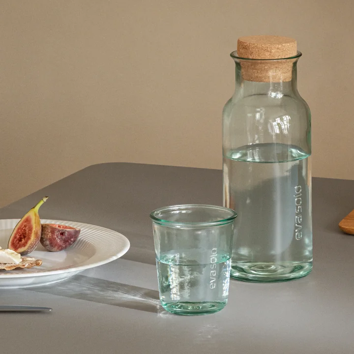 Recycled carafe with cork and recycled drinking glass by Eva Solo