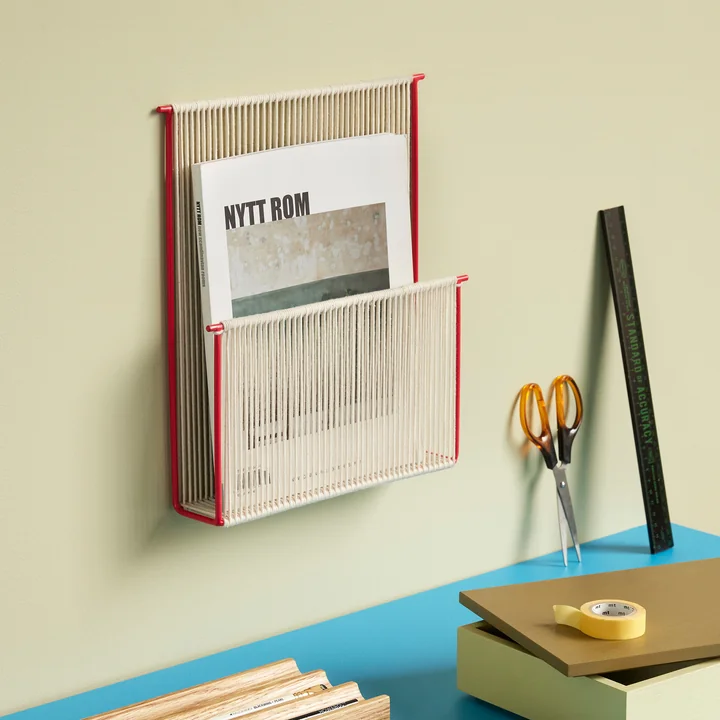 Stylish magazine holder above the desk