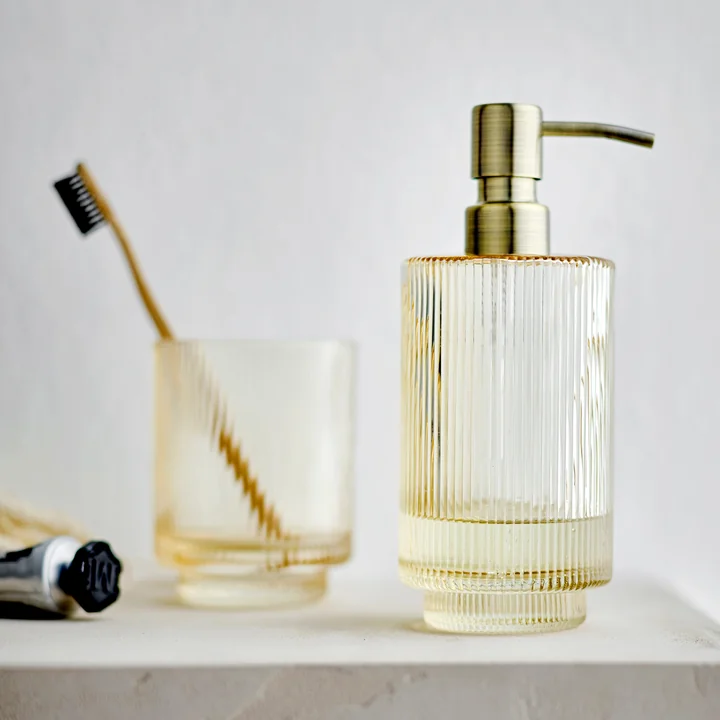 Clarity Soap dispenser and toothbrush mug from Södahl in color golden yellow
