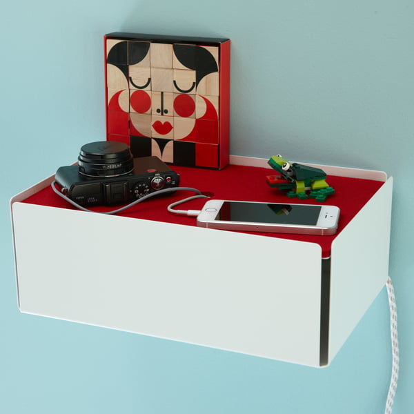Miller Goodman's FaceMaker on the white and red Charge-Box charging station from Konstantin Slawinski on the wall