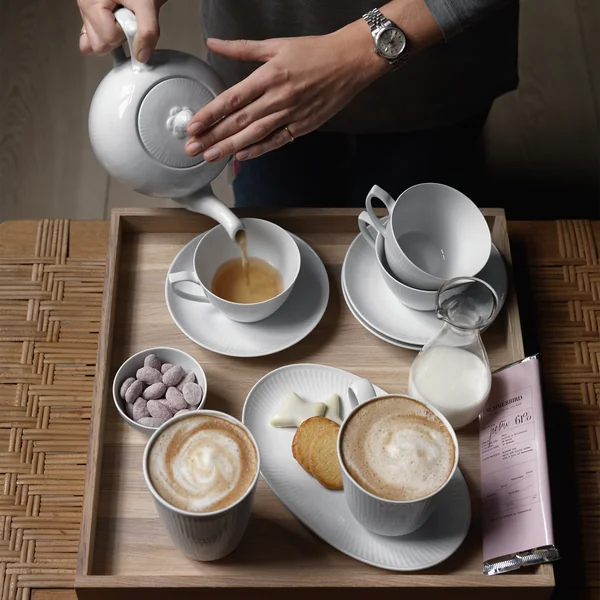 White Ribbed cup, pot and plate from Royal Copenhagen on the coffee table