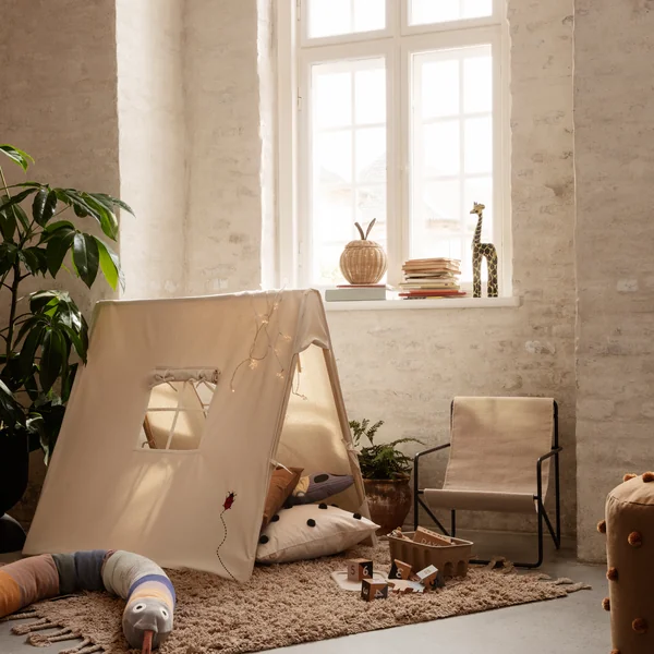 The Desert Chair Kids by Ferm Living in an organically furnished children's room with play tent and cosy rug
