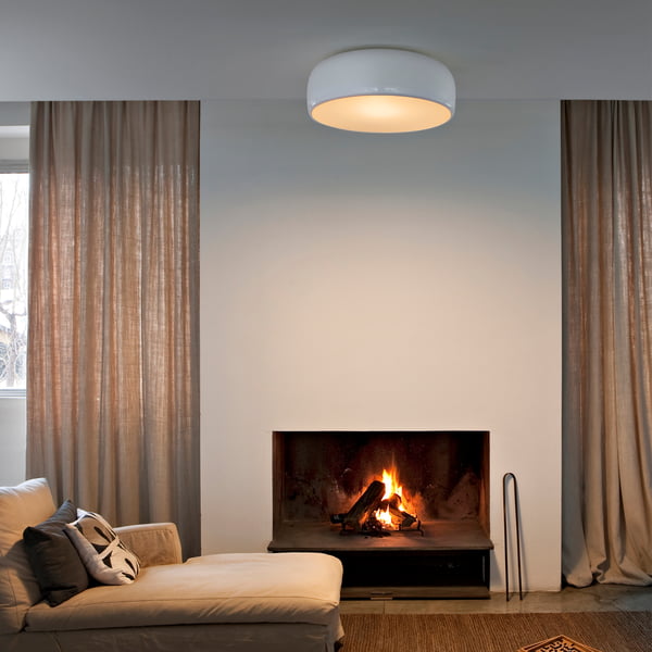 The Smithfield Pro ceiling lamp from Flos in the living room above a beige couch with fireplace