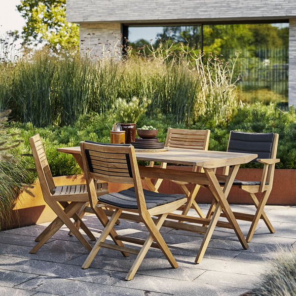 The Flip folding chair Outdoor from Cane-line on the green planted terrace